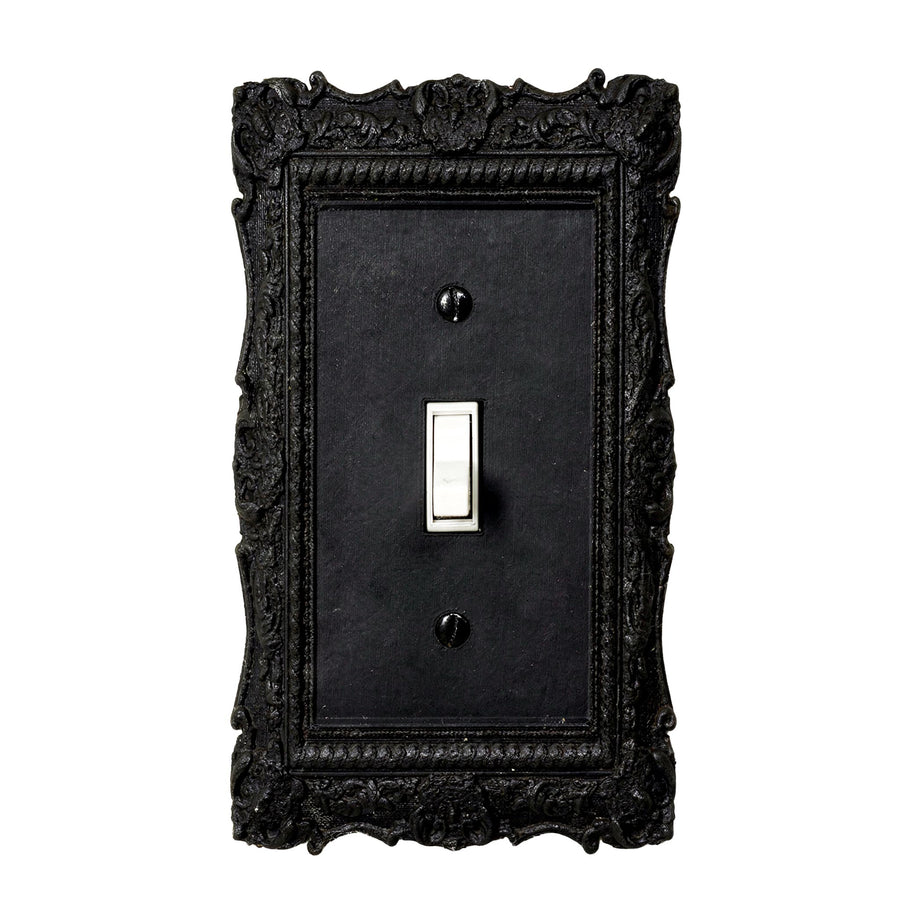 Versailles Victorian black light switch cover mounted on a wall, single toggle
